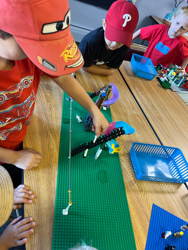 Students building with LEGOs at a classroom table